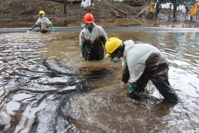 Trabajadores limpian uno de los dos vertimientos de petróleo ocurridos en agosto a lo largo del Oleoducto Norperuano, en la comunidad de Nueva Alianza. Foto: Copyright © Barbara Fraser.